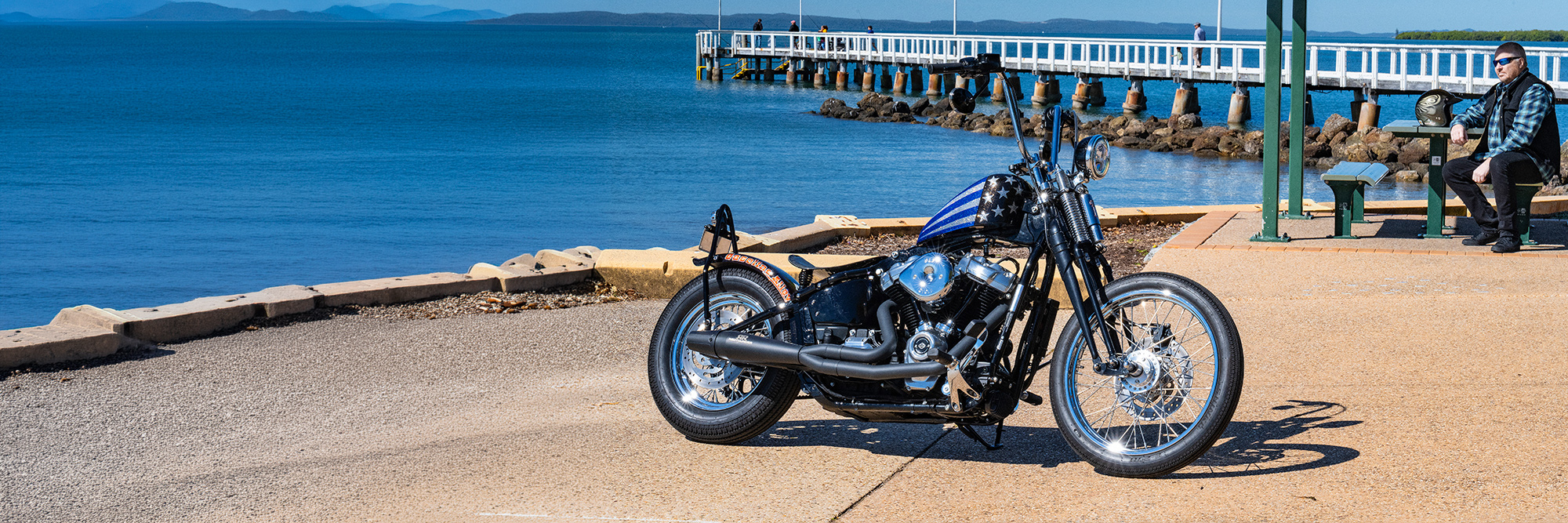 Custom motorcycle photographed beside the waterfront